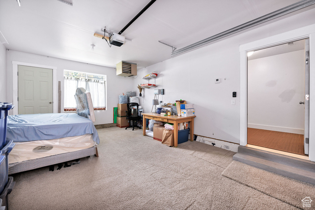 Bedroom with a garage and baseboards