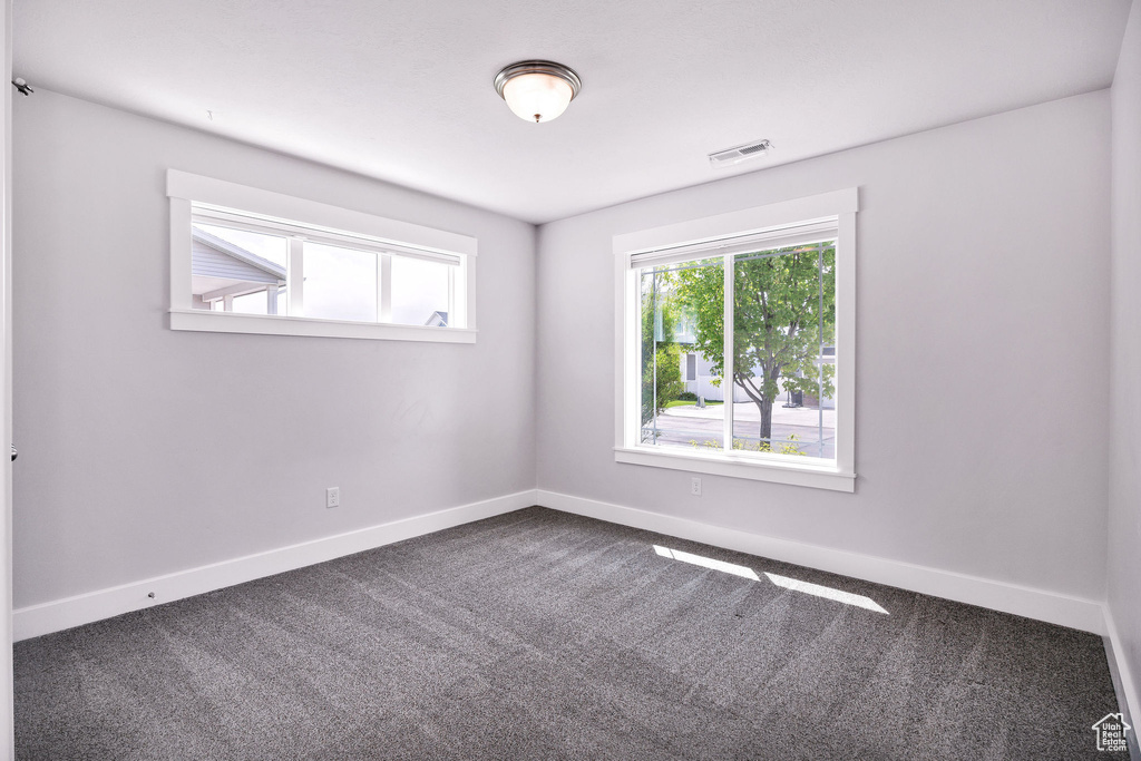 Carpeted empty room with baseboards