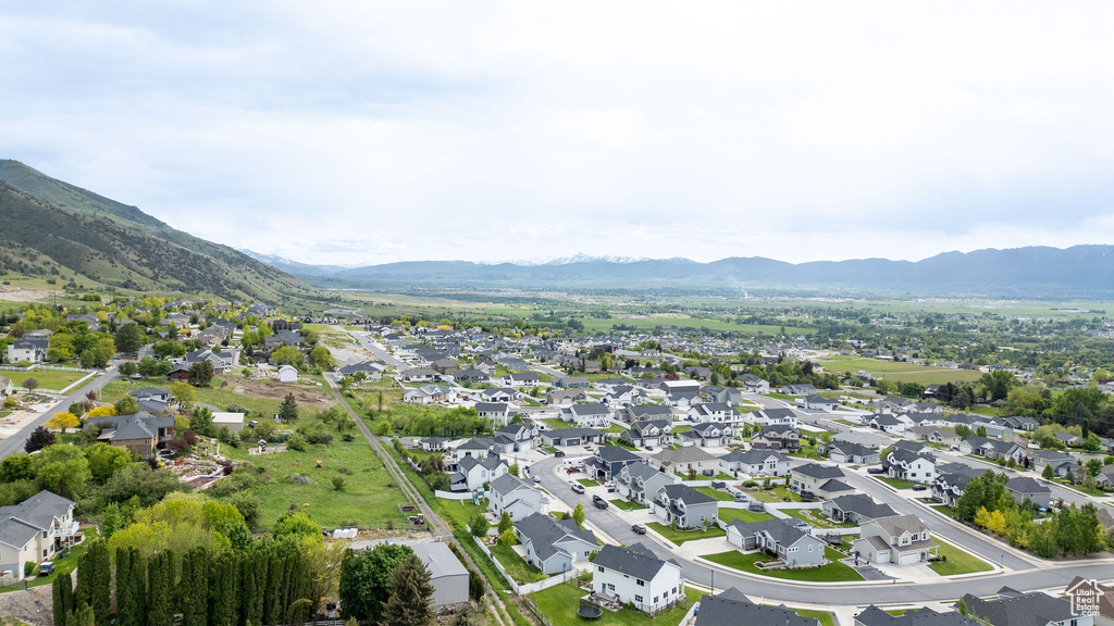 Aerial view of property\'s location featuring a mountainous background and nearby suburban area