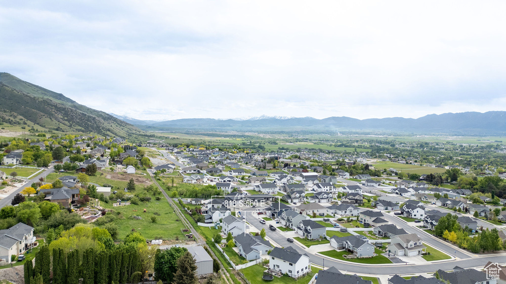 Aerial view of property\'s location featuring a mountain backdrop and nearby suburban area