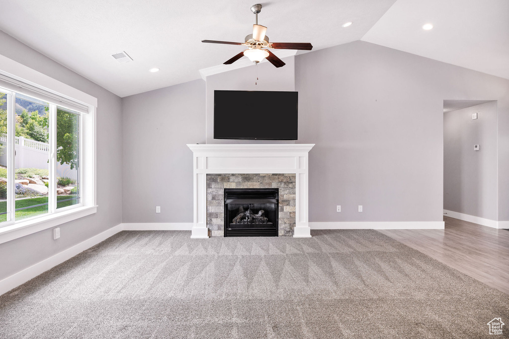 Unfurnished living room with lofted ceiling, a ceiling fan, a fireplace, baseboards, and recessed lighting