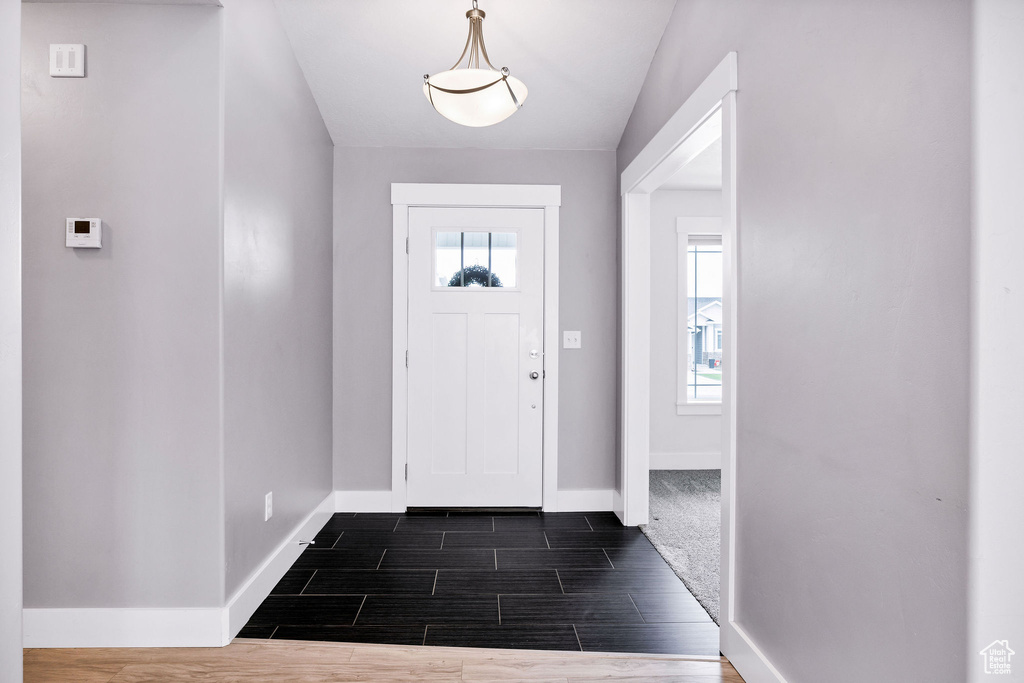 Entrance foyer featuring baseboards and wood finish floors