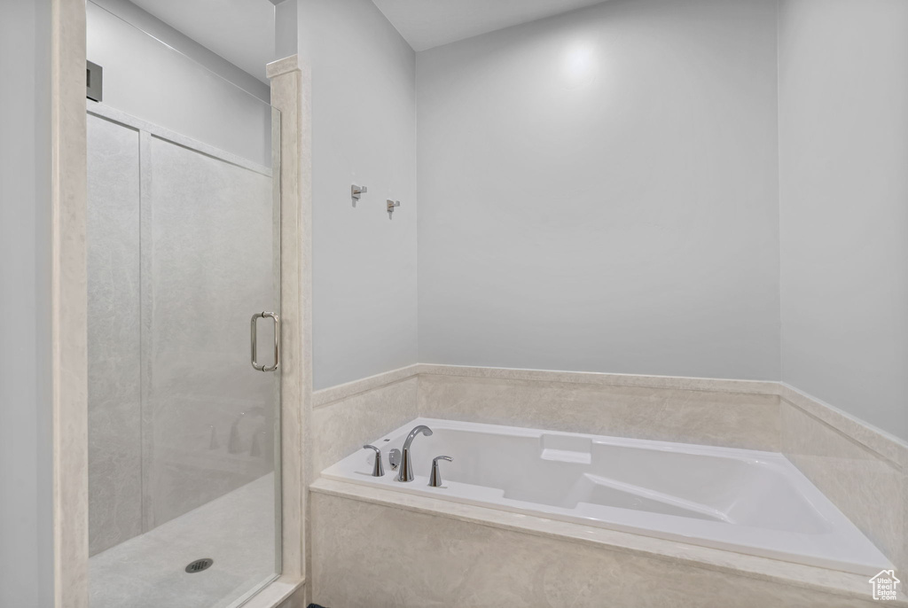 Full bath with a shower stall and a garden tub