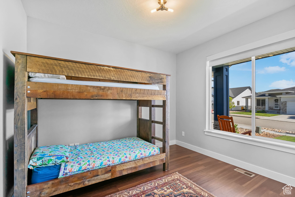 Bedroom with baseboards and wood finished floors