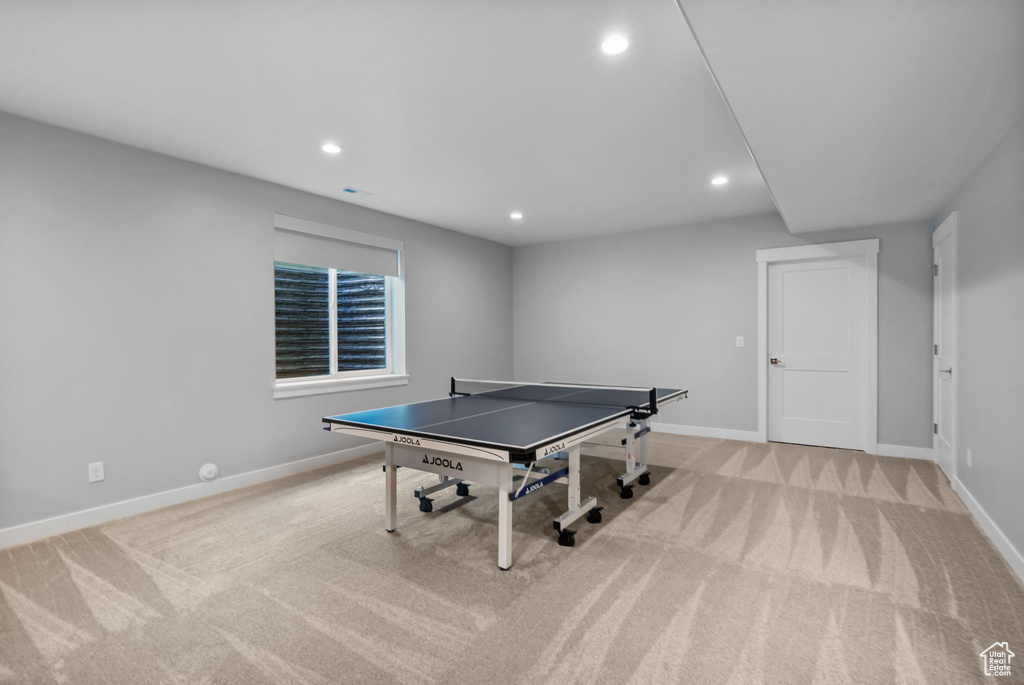 Rec room with light colored carpet, baseboards, and recessed lighting