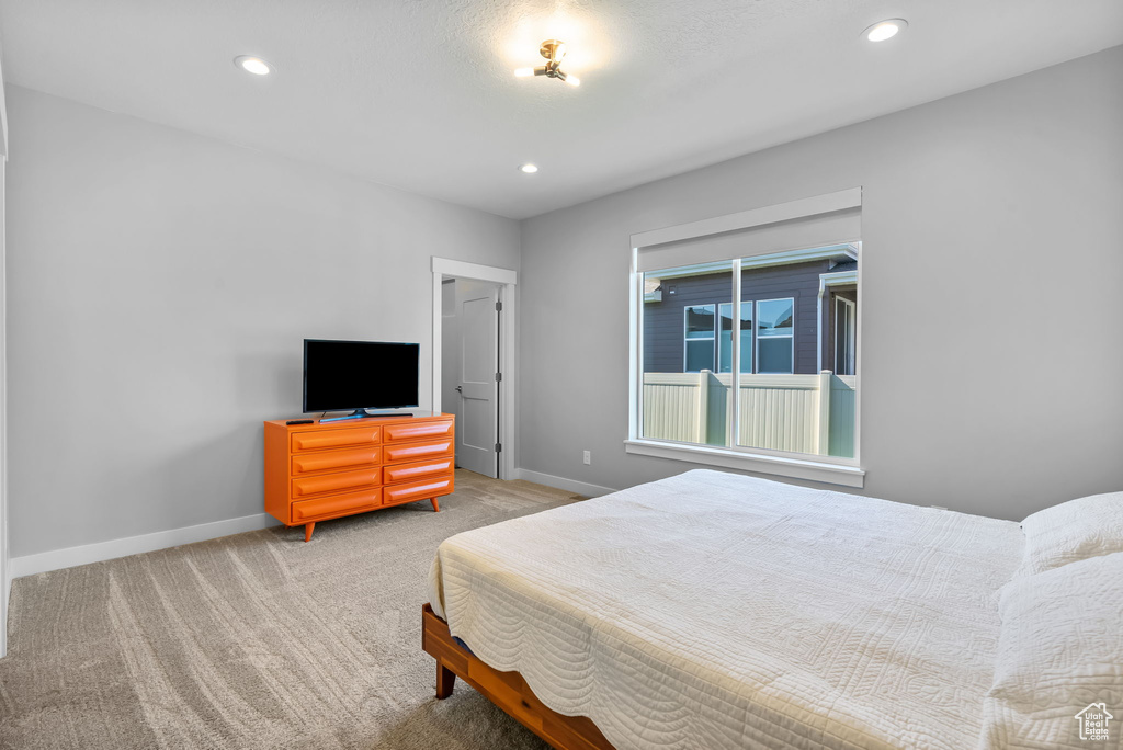 Carpeted bedroom featuring baseboards and recessed lighting