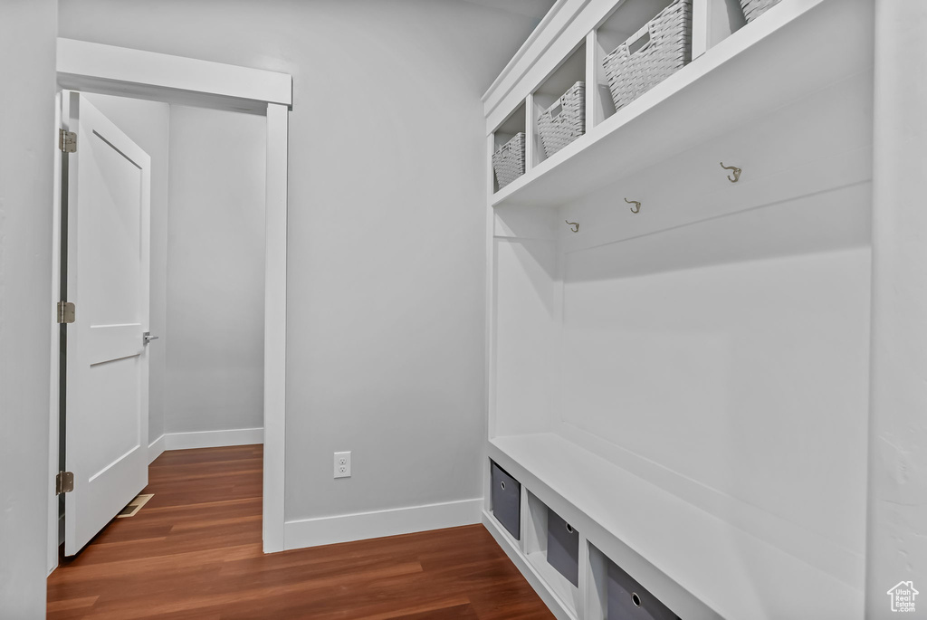Mudroom with baseboards and dark wood-type flooring