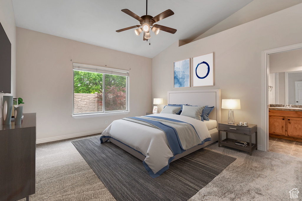 Bedroom featuring carpet flooring, lofted ceiling, ensuite bath, baseboards, and ceiling fan