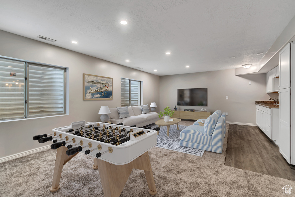 Game room with carpet flooring, baseboards, recessed lighting, and a sink