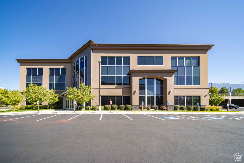 View of building exterior with uncovered parking