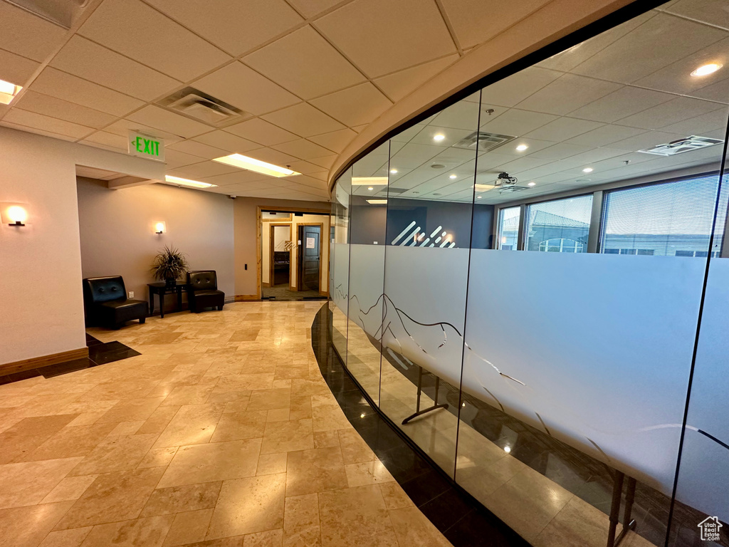 Corridor featuring baseboards, recessed lighting, and stone finish flooring
