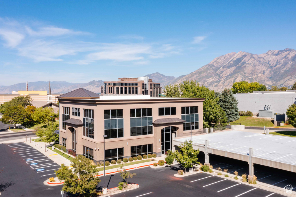 View of property featuring uncovered parking and a mountain view