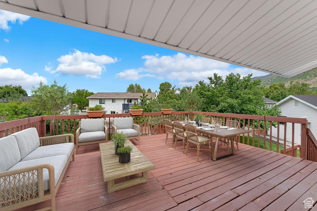 Deck featuring outdoor dining area and an outdoor hangout area