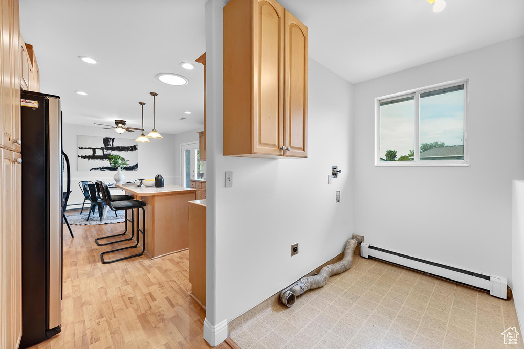 Washroom featuring a baseboard radiator, healthy amount of natural light, ceiling fan, hookup for an electric dryer, and recessed lighting