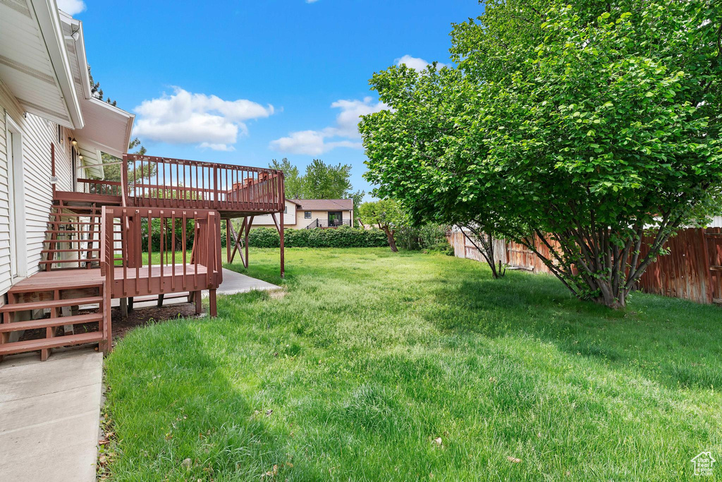 View of yard with a deck and stairway