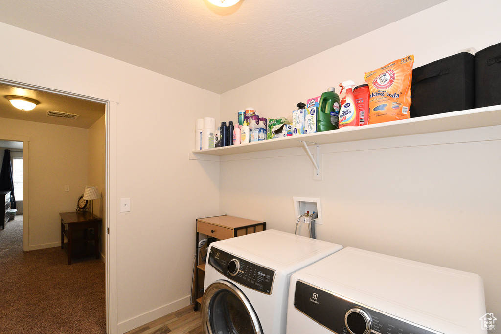 Laundry area with separate washer and dryer and baseboards