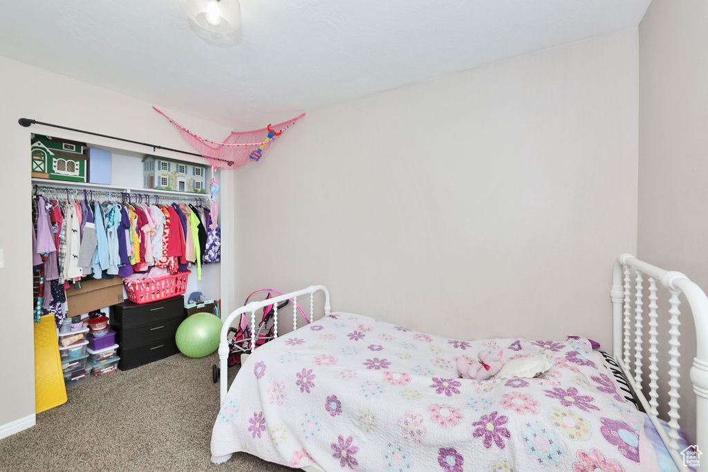 Carpeted bedroom featuring a closet