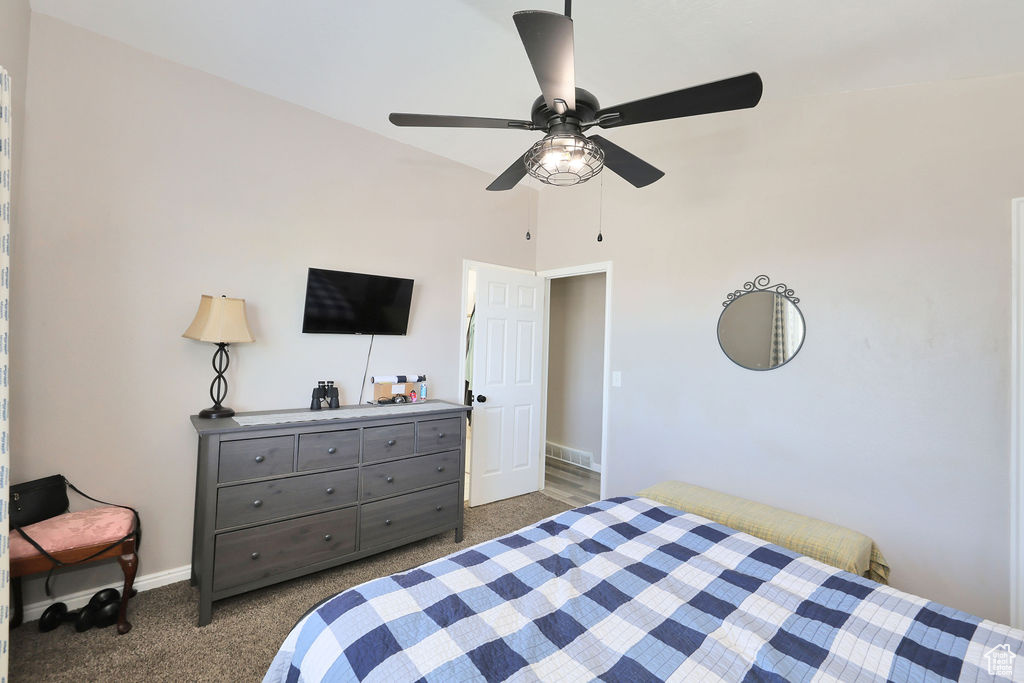 Carpeted bedroom with baseboards and a ceiling fan