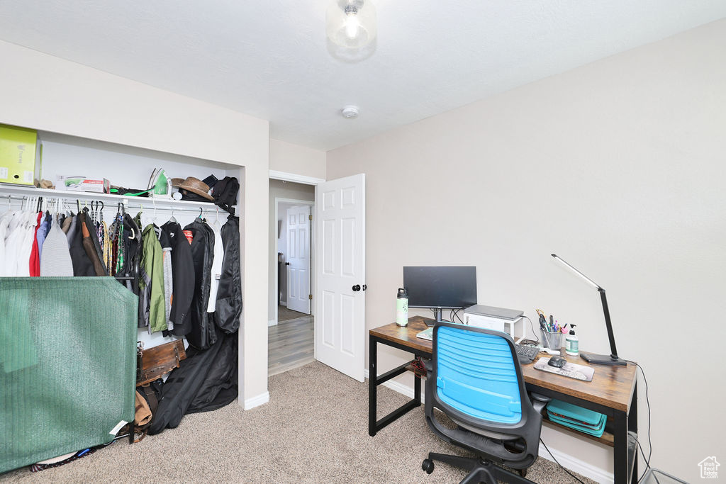 Carpeted office space featuring baseboards
