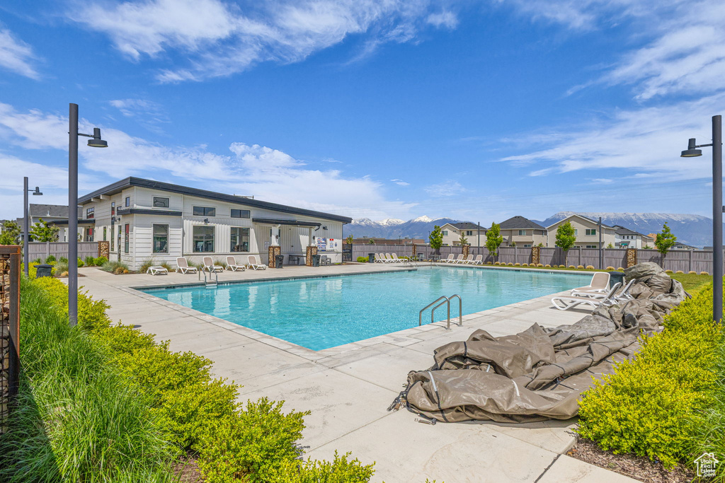 Community pool with a patio area and a mountain view