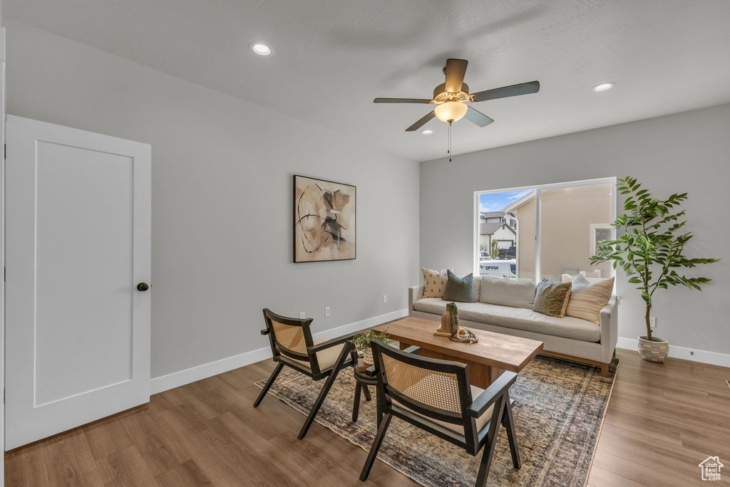 Living area with ceiling fan, wood finished floors, baseboards, and recessed lighting