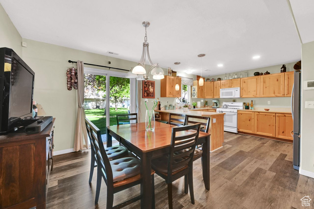 Dining room with dark wood-type flooring, recessed lighting, and baseboards