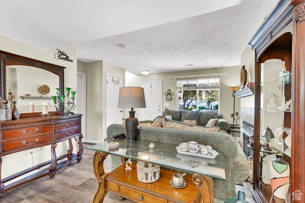 Living room with baseboards and a textured ceiling