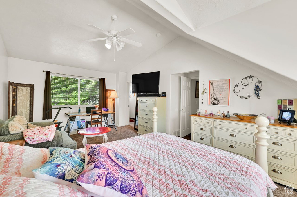 Bedroom with vaulted ceiling, carpet flooring, and ceiling fan