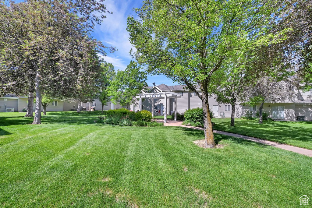 View of green lawn featuring a pergola