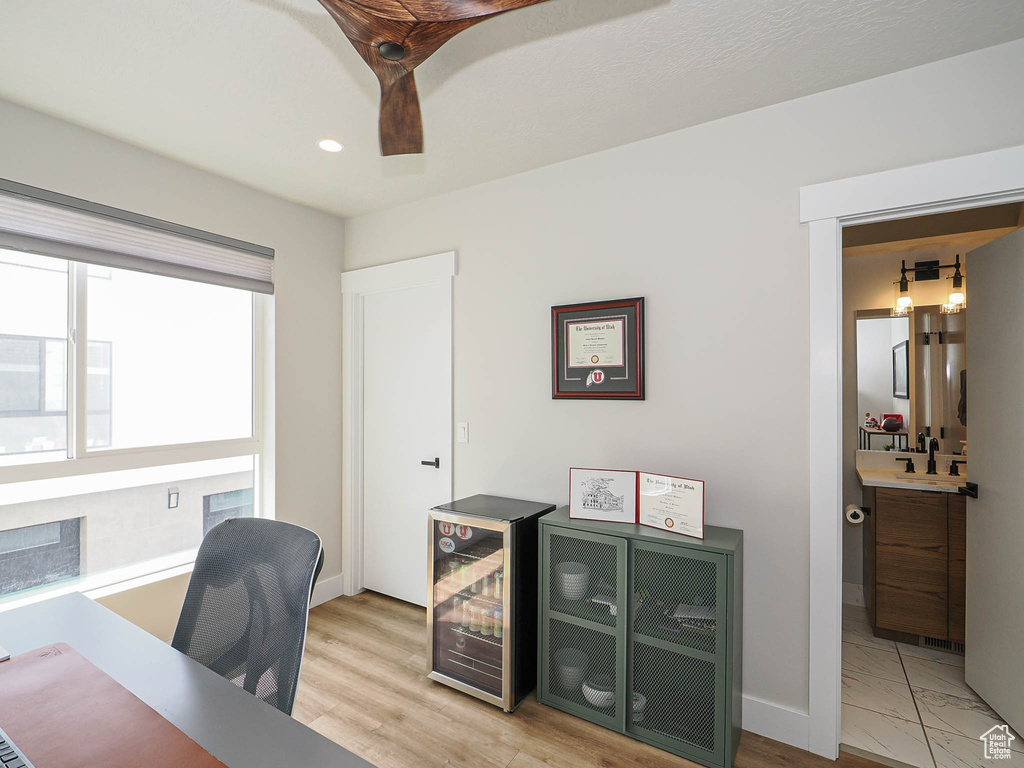 Office area with baseboards, wine cooler, recessed lighting, and bar area