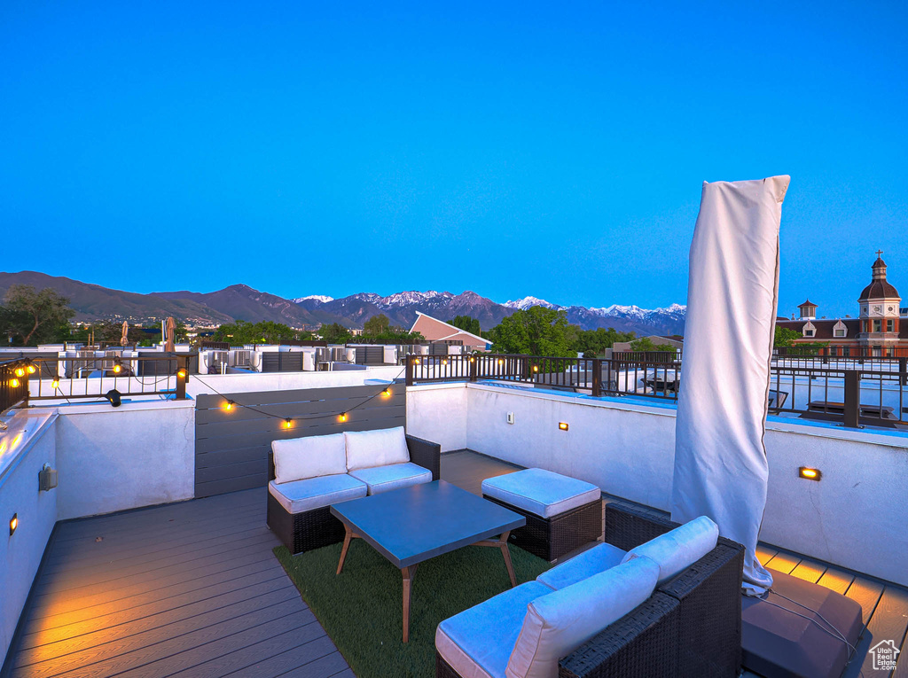 Deck featuring a mountain view and an outdoor living space