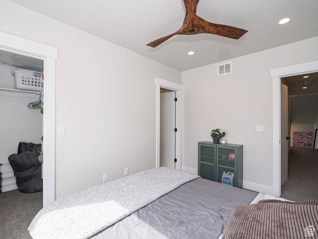 Carpeted bedroom featuring recessed lighting, a closet, ceiling fan, and a spacious closet
