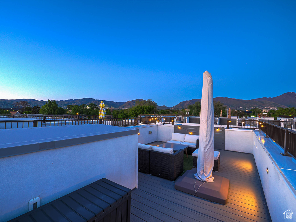 Deck with a mountain view and outdoor lounge area