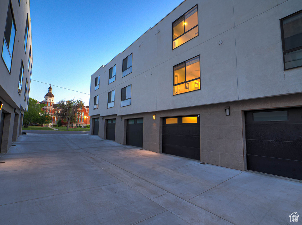 View of property featuring a garage and driveway