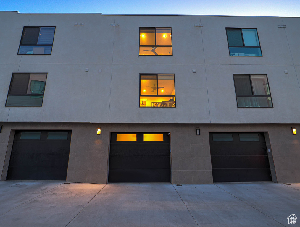 View of property with an attached garage and driveway