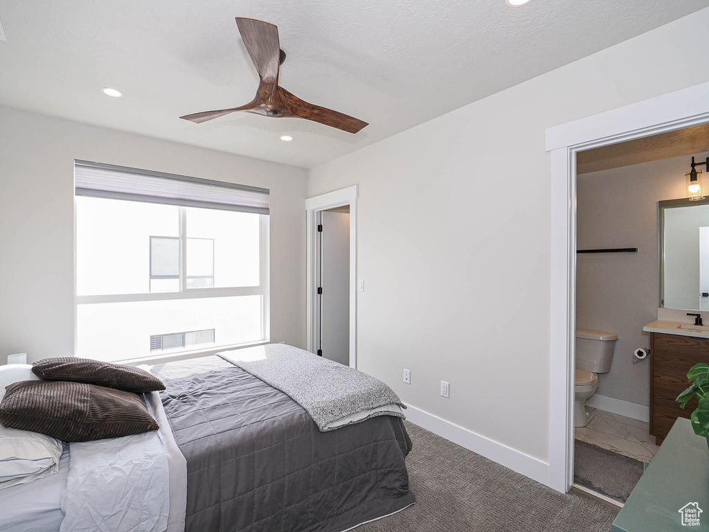 Bedroom featuring dark carpet, recessed lighting, baseboards, connected bathroom, and a ceiling fan