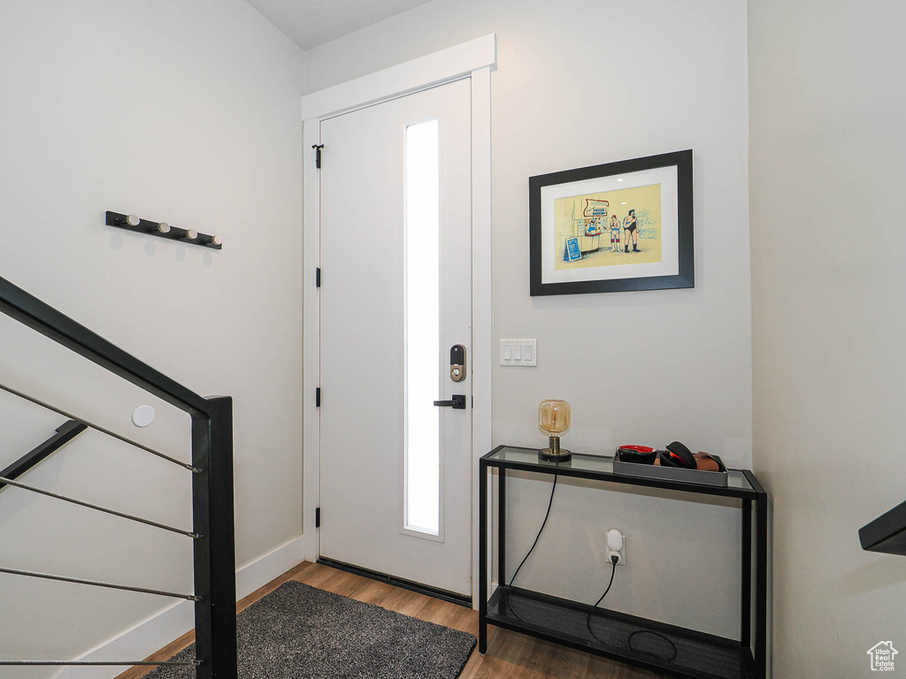 Entryway featuring wood finished floors and baseboards