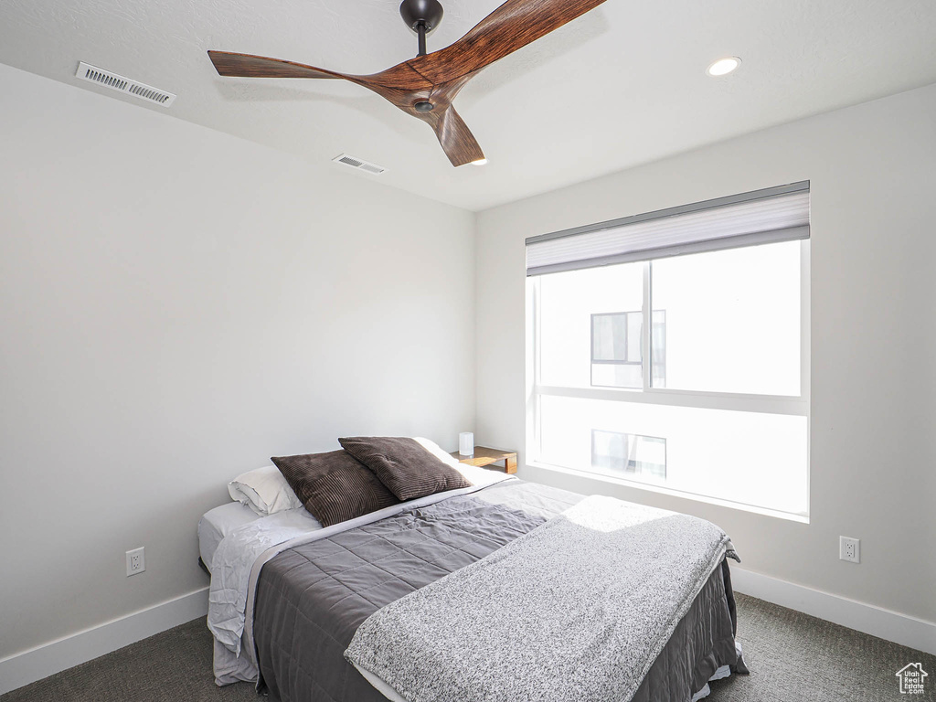 Bedroom featuring dark carpet, baseboards, ceiling fan, and recessed lighting