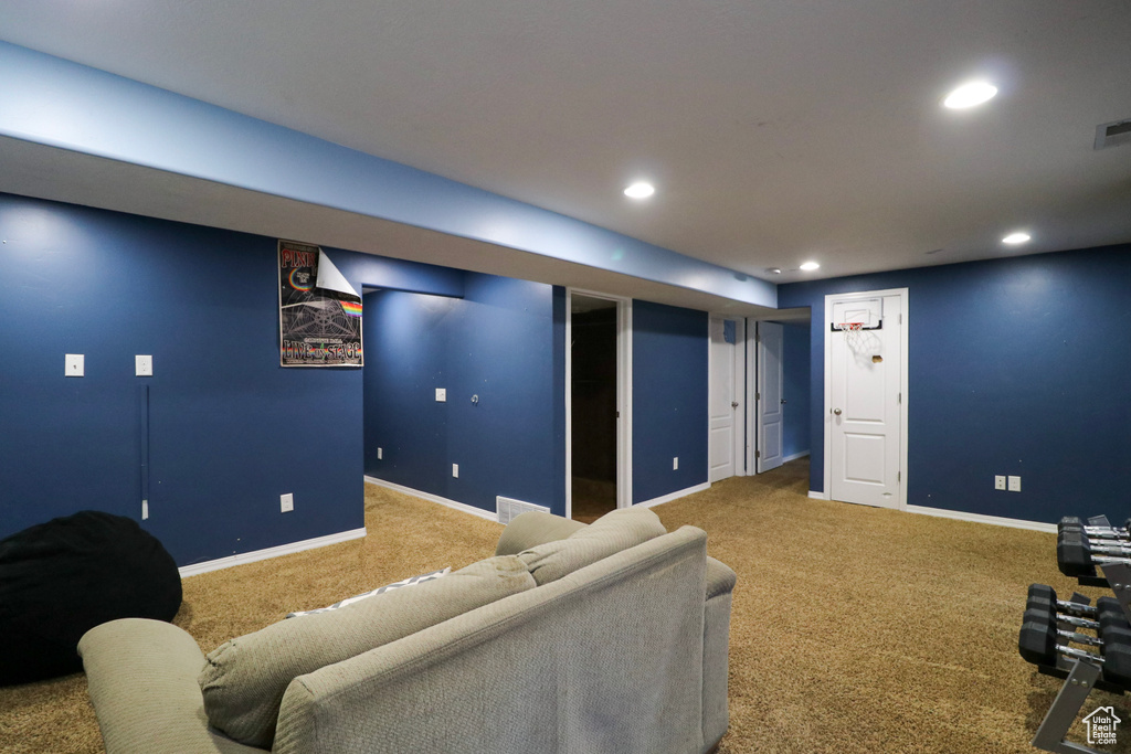 Carpeted living room with recessed lighting and baseboards