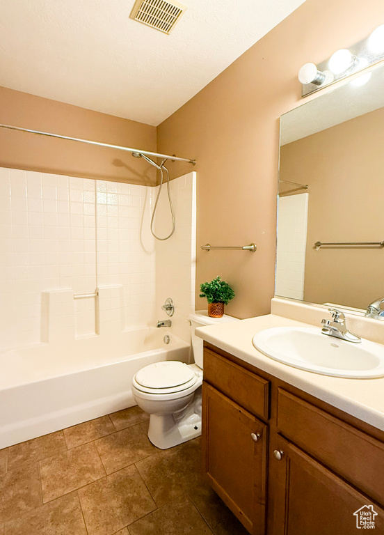 Full bath with toilet, vanity, shower / bath combination, and tile patterned floors