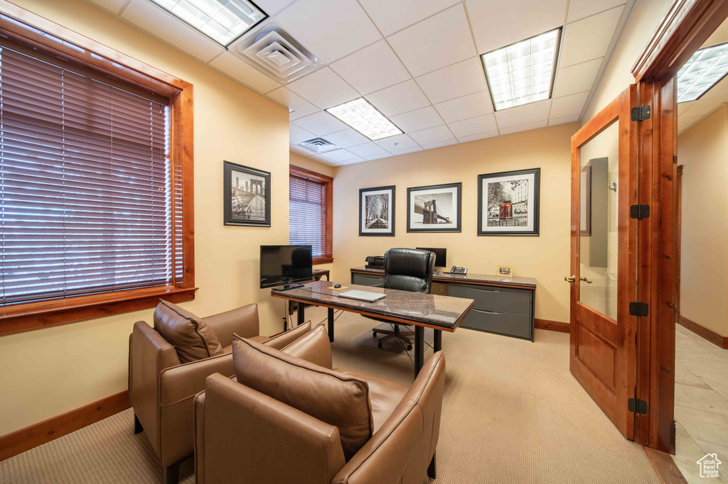 Carpeted office space with baseboards, french doors, and a paneled ceiling