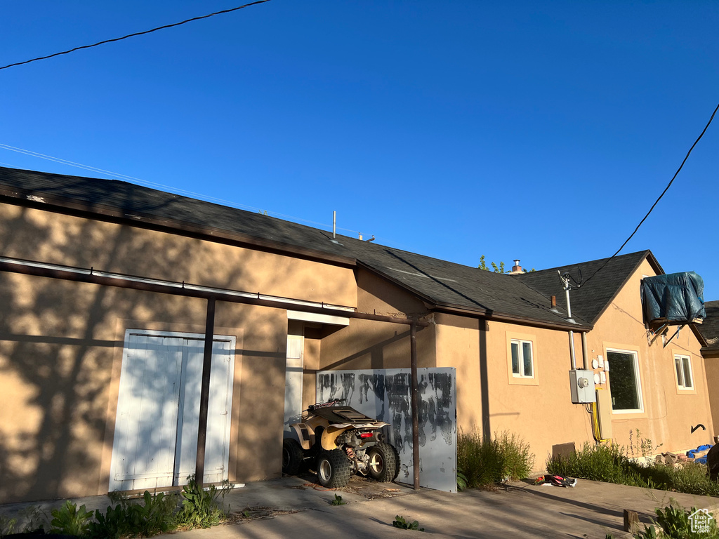 View of side of property featuring stucco siding