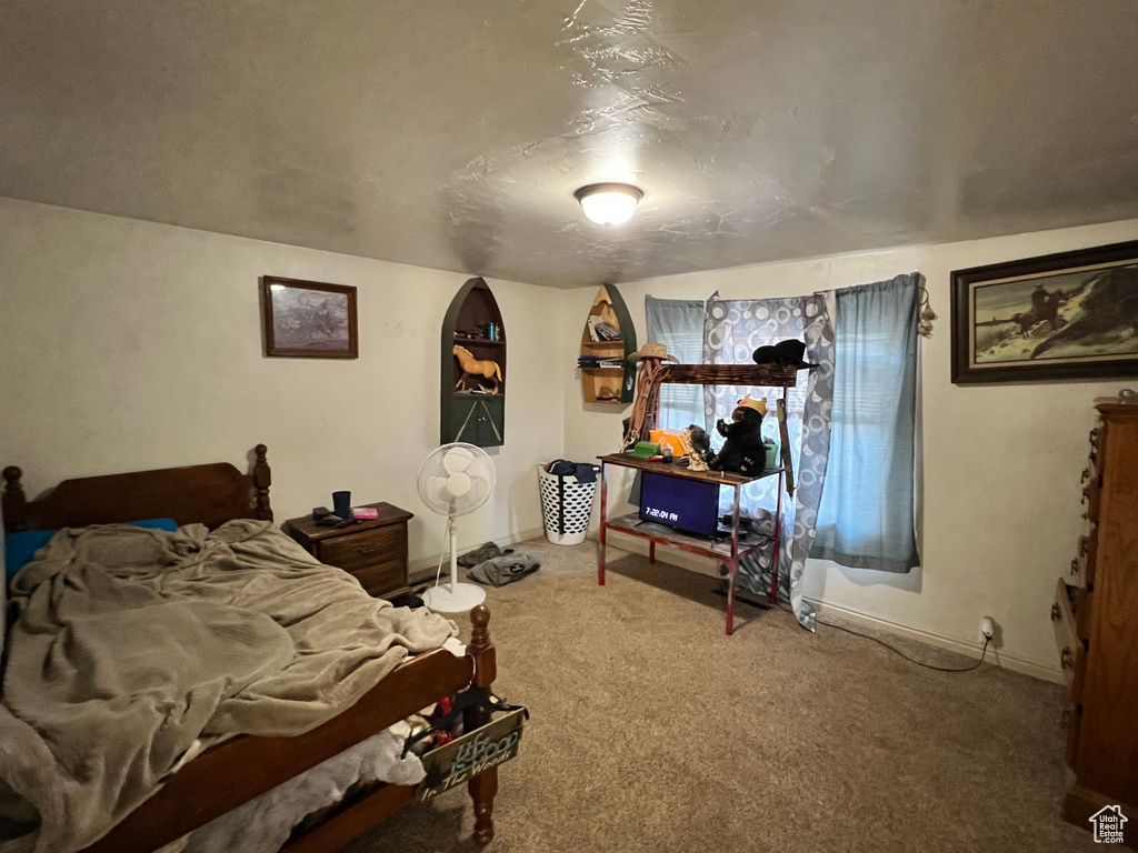 Carpeted bedroom with baseboards