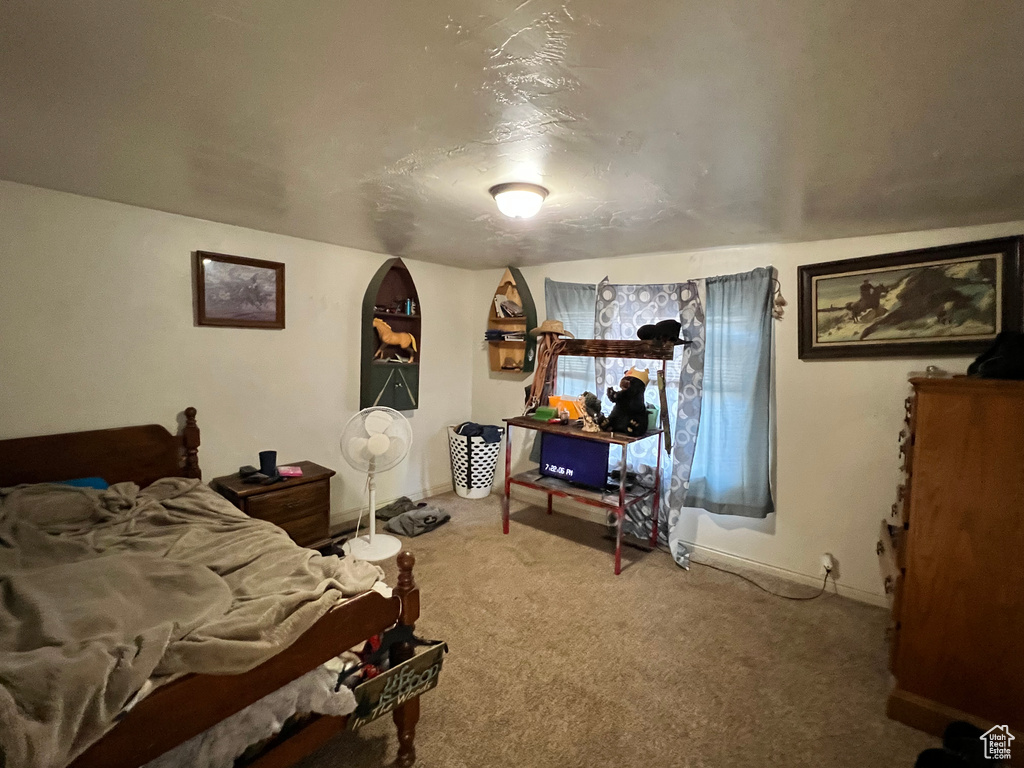 Bedroom with carpet floors and baseboards