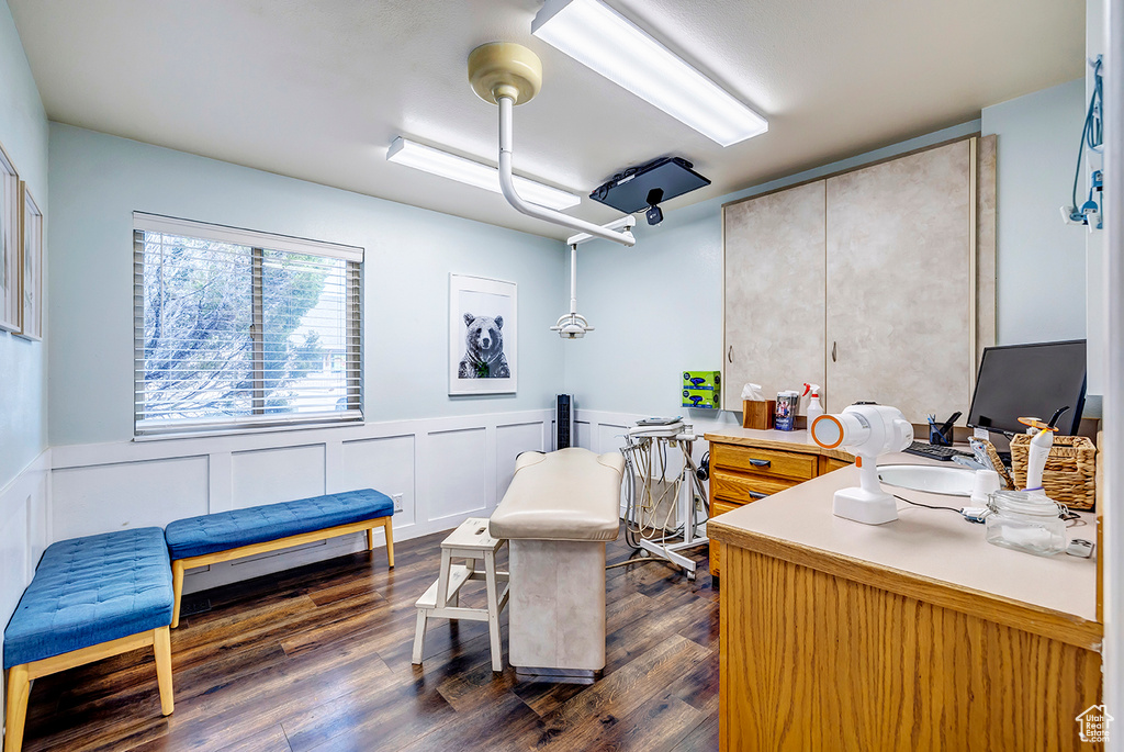 Office featuring a wainscoted wall and dark wood finished floors