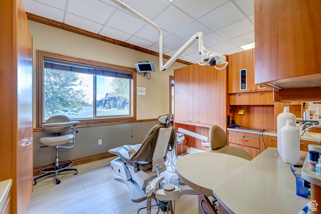 Office space featuring light wood-style flooring and ornamental molding
