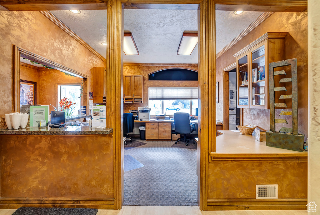Office area with crown molding and wood finished floors