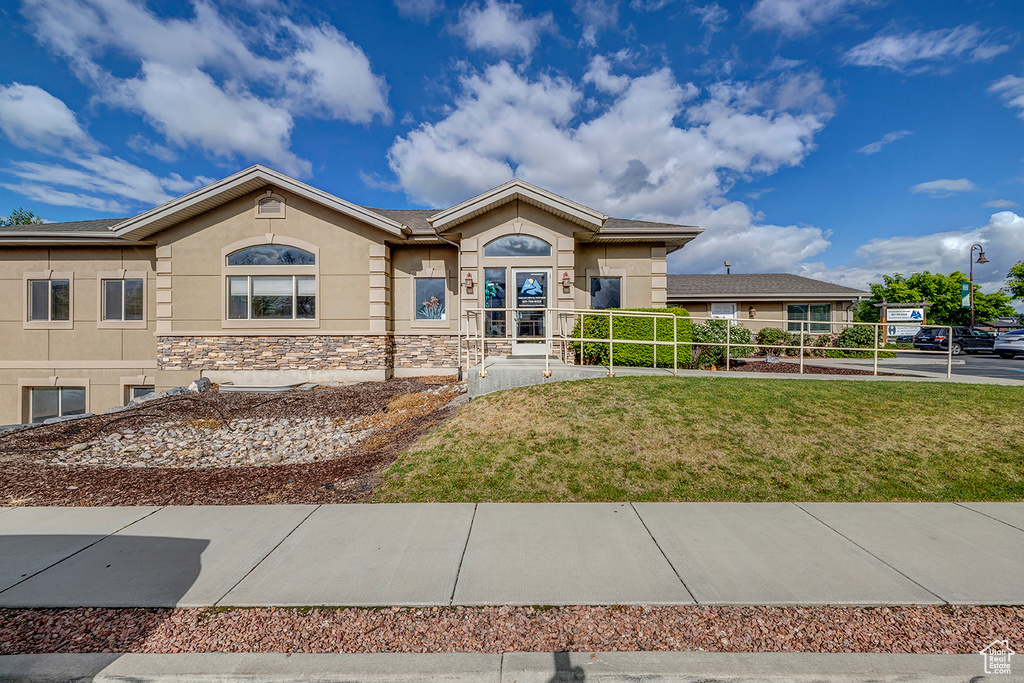 View of front of property with stucco siding and stone siding