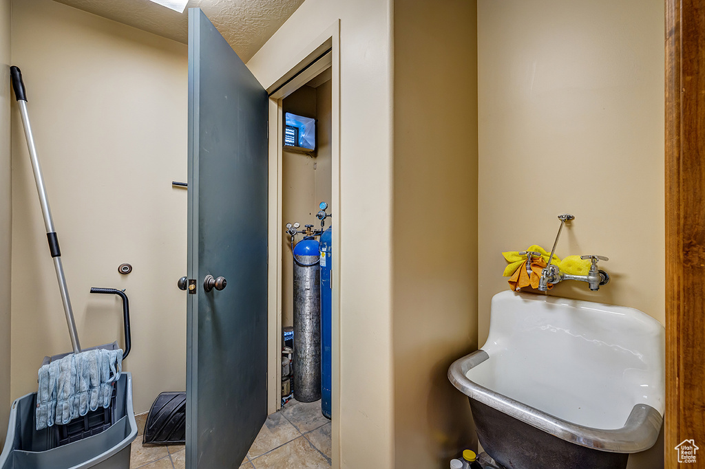 Bathroom with tile patterned flooring and a freestanding bath