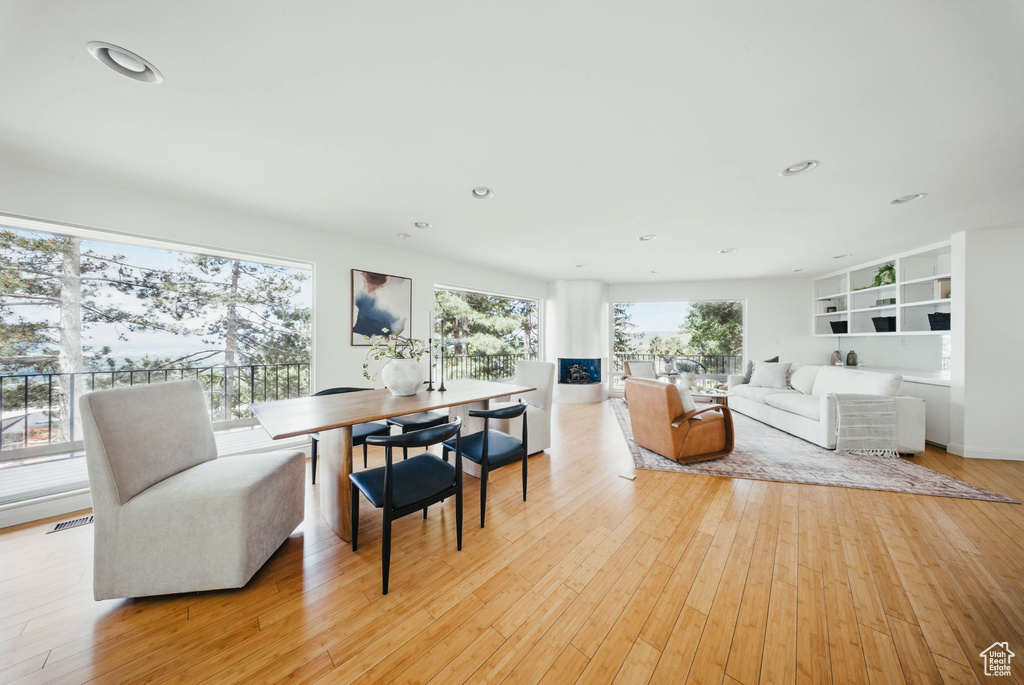 Living room with light wood-style flooring and recessed lighting